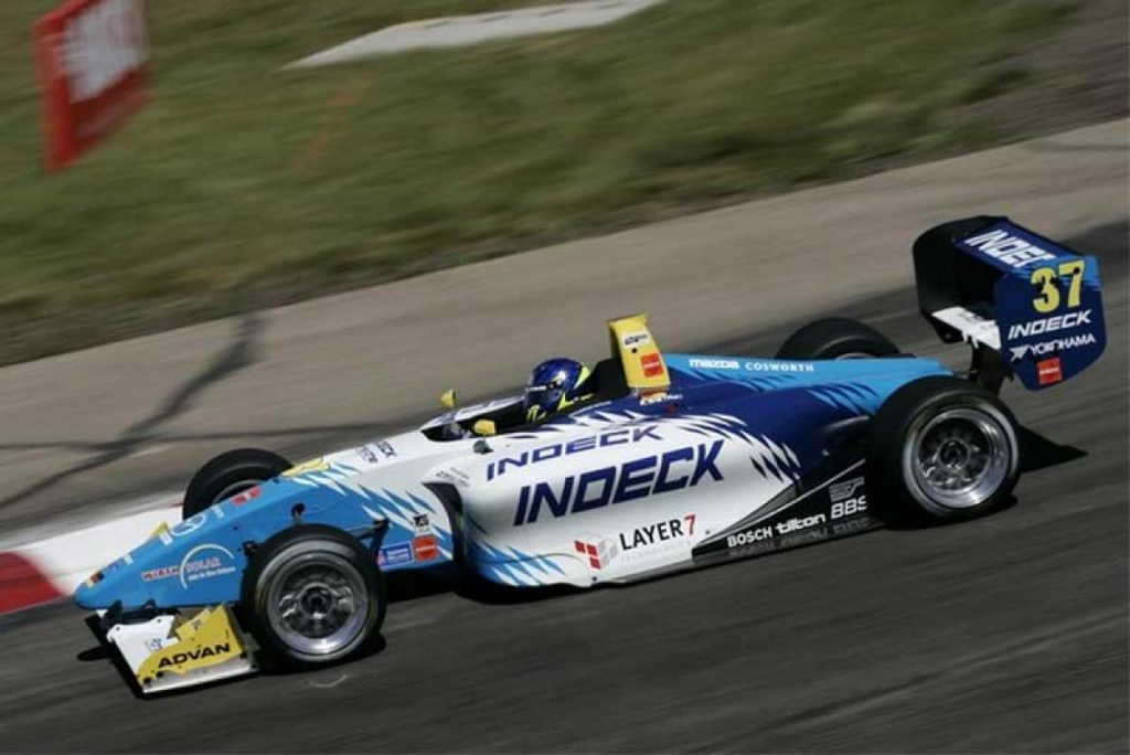 A man driving a race car on a track